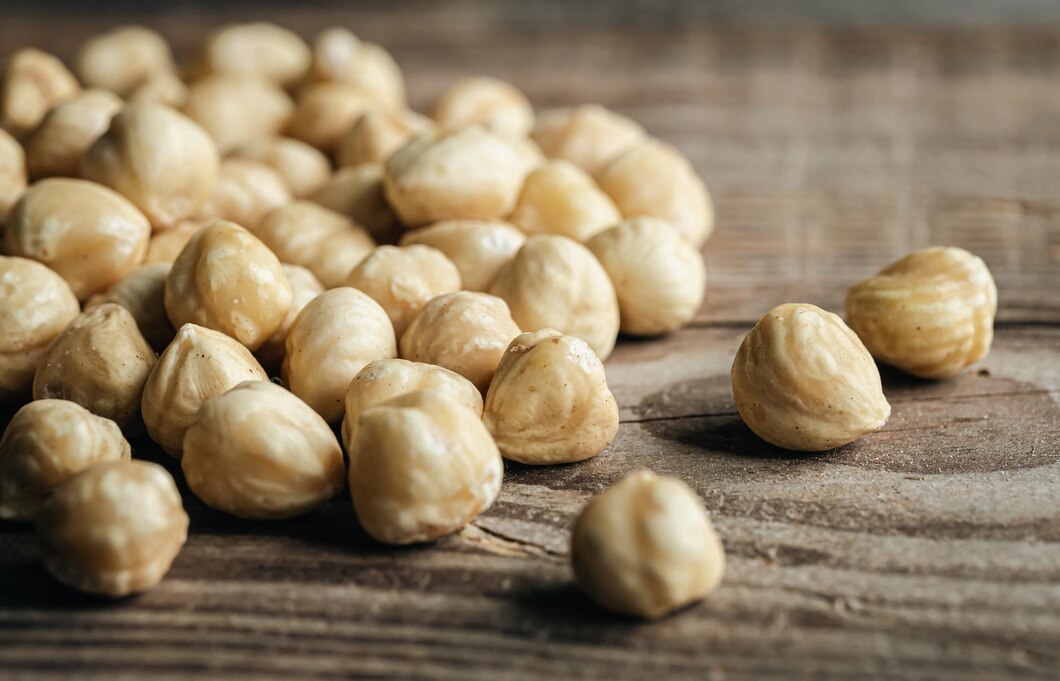 heap-roasted-hazelnuts-closeup-wooden-background_169016-27773